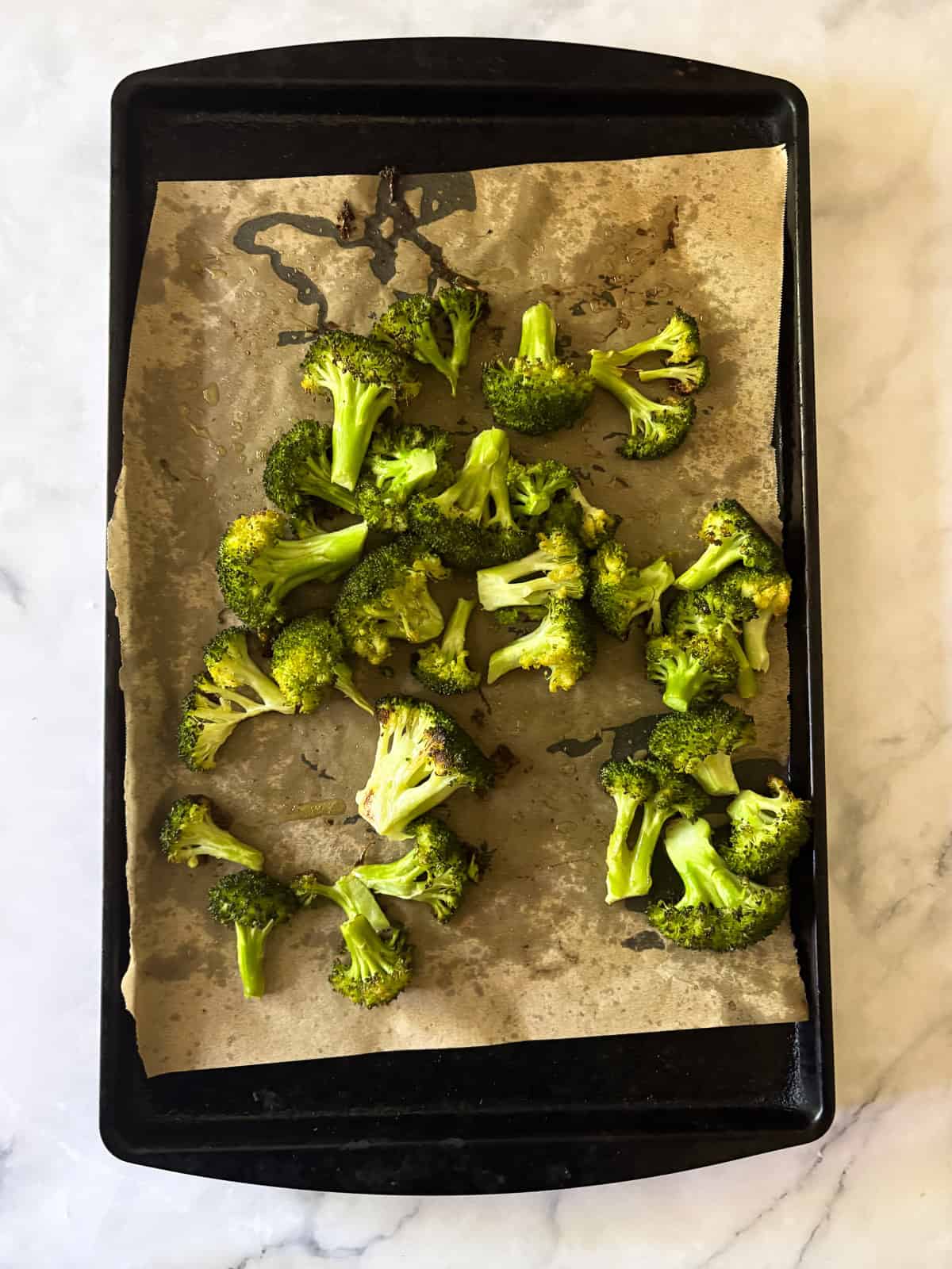 An easy recipe for roasted broccoli that can be boosted with lemon juice or zest, garlic, red pepper flakes - or simply dusted with Parmesan. Parmesan roasted broccoli after being baked.