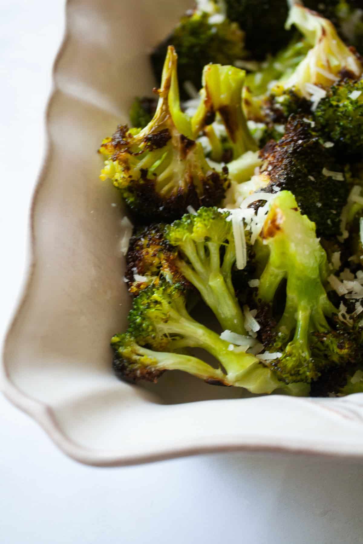 An easy recipe for roasted broccoli that can be boosted with lemon juice or zest, garlic, red pepper flakes - or simply dusted with Parmesan. Parmesan cheese on the top of parmesan roasted broccoli.