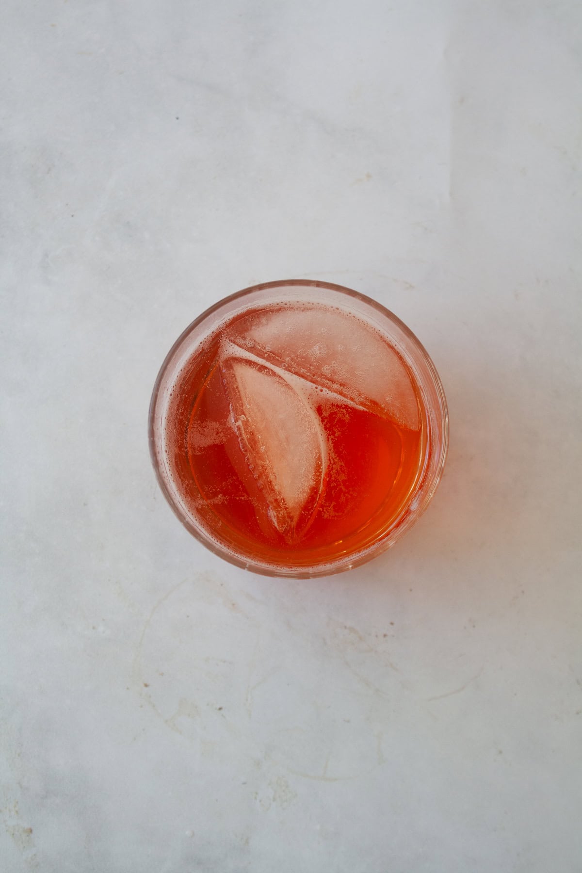 Enjoy this strawberry gin and tonic all summer long! A fruit twist on a classic, sweet strawberry syrup elevates this familiar cocktail. Ice and tonic are added to make a strawberry gin and tonic.