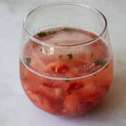 A glass of strawberry mocktail with mint.