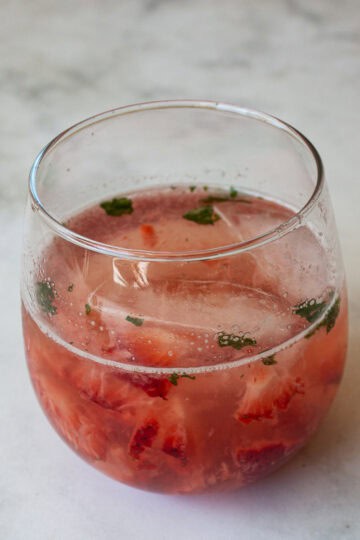 A glass of strawberry mocktail with mint.