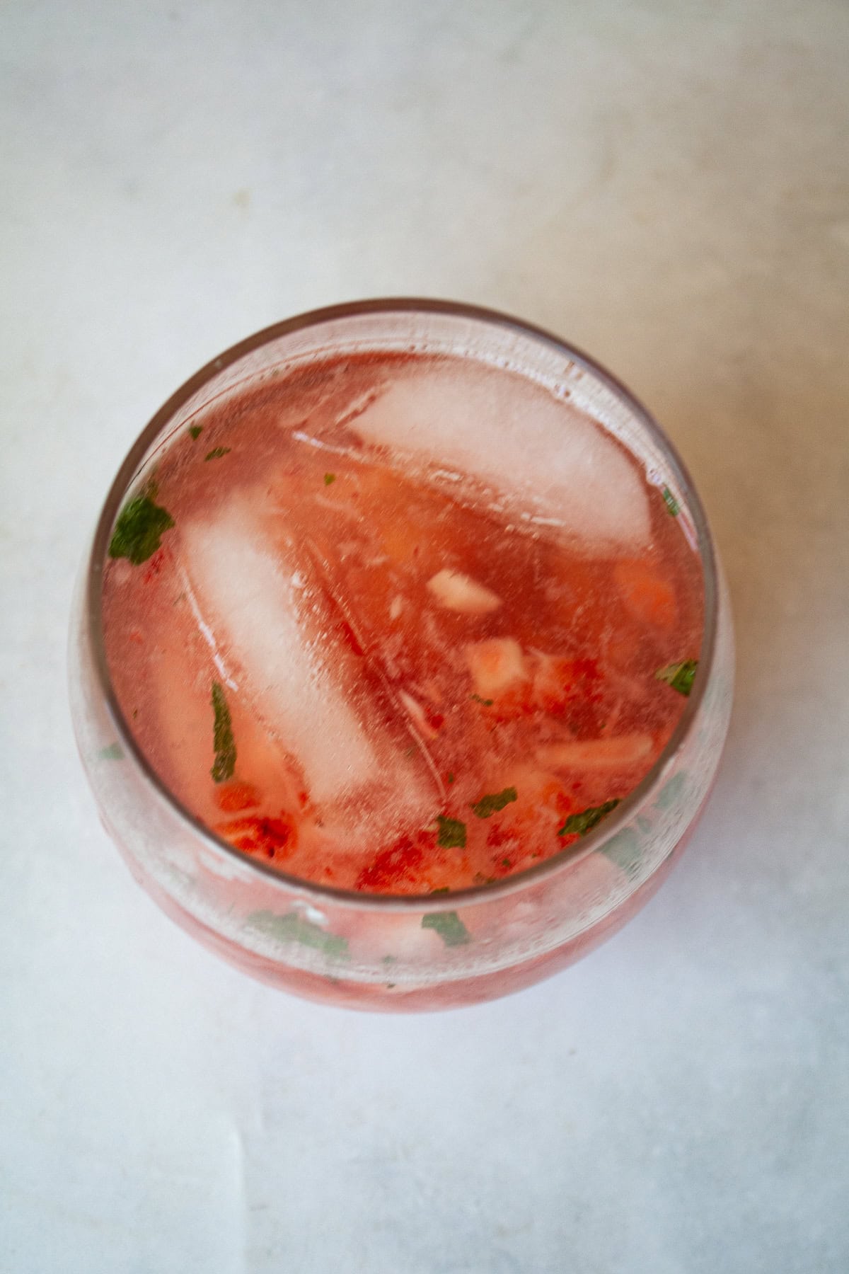 This strawberry mocktail is a not-too-sweet, non-alcoholic drink featuring juicy strawberries muddled with honey, lime, and mint.