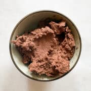 Chocolate cookie dough in a bowl, ready for baking.