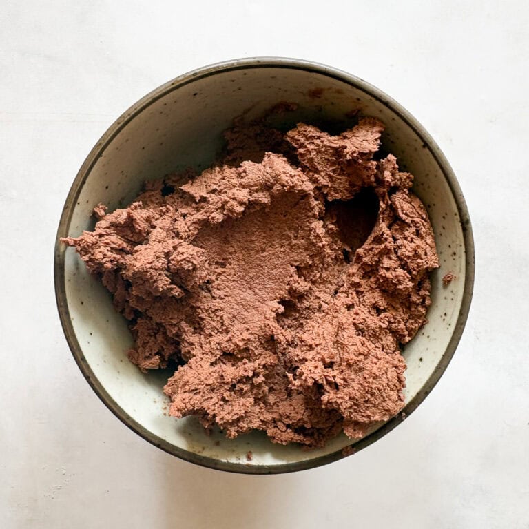 Chocolate cookie dough in a bowl, ready for baking.