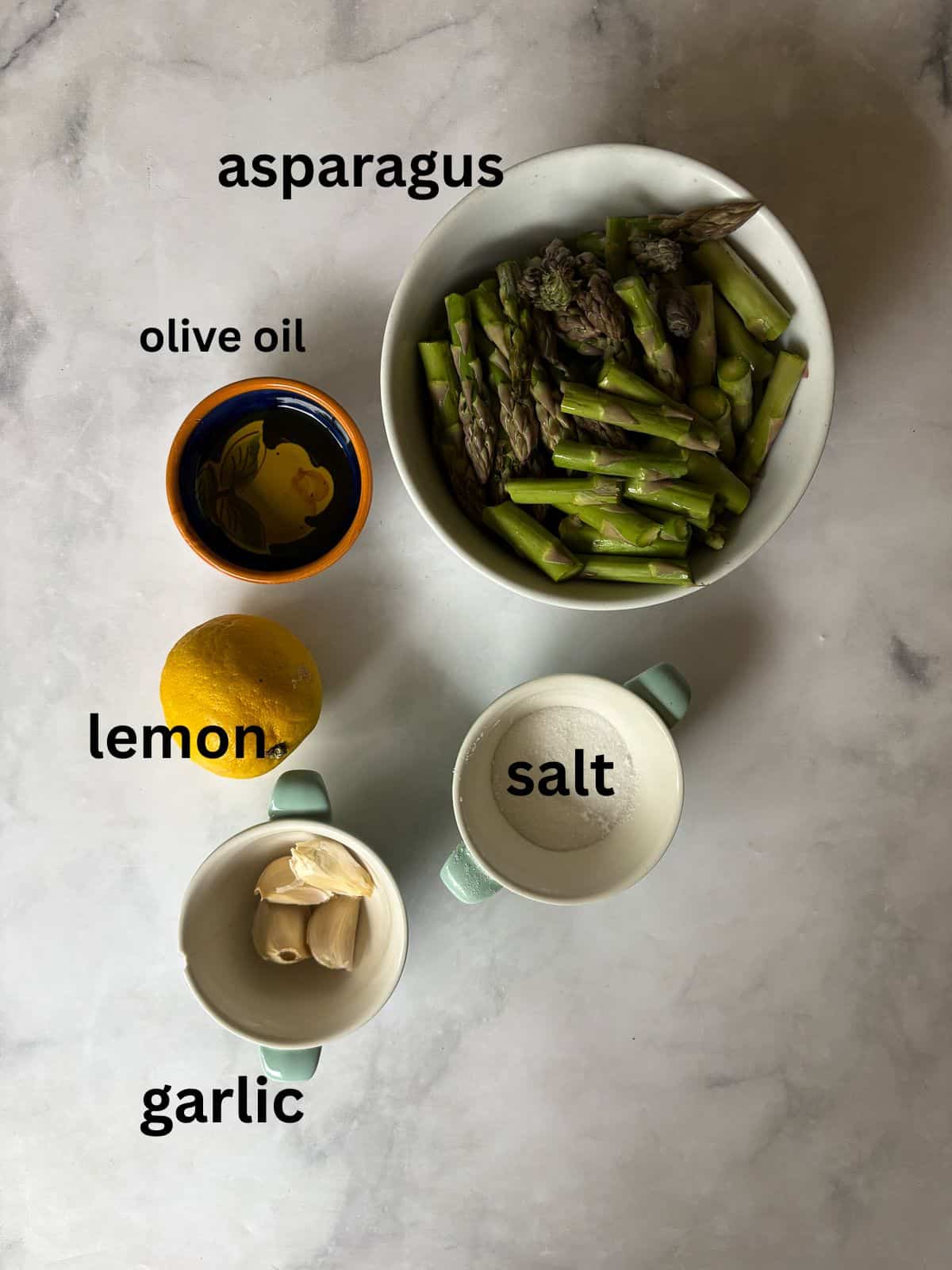 Cook to taste. I love that sweet spot between cooked through and still firm. You can cook the asparagus a bit more if you prefer softer asparagus and conversely, can cook it a little less for firmer asparagus. Herbs. Stir in some chopped fresh or dried herbs to the pan, such as parsley, basil, or oregano. Add more garlic. This recipe takes well to adjustments. Add more garlic if you like a lot of garlic. You can also use less. Serve cold. While I tend to serve this sautee with a hot meal, it's also lovely cold! You could mix it with quinoa and chickpeas to make a warm-weather side dish, or add leftover asparagus to a salad. Ingredients for asparagus and lemon are text-labeled.