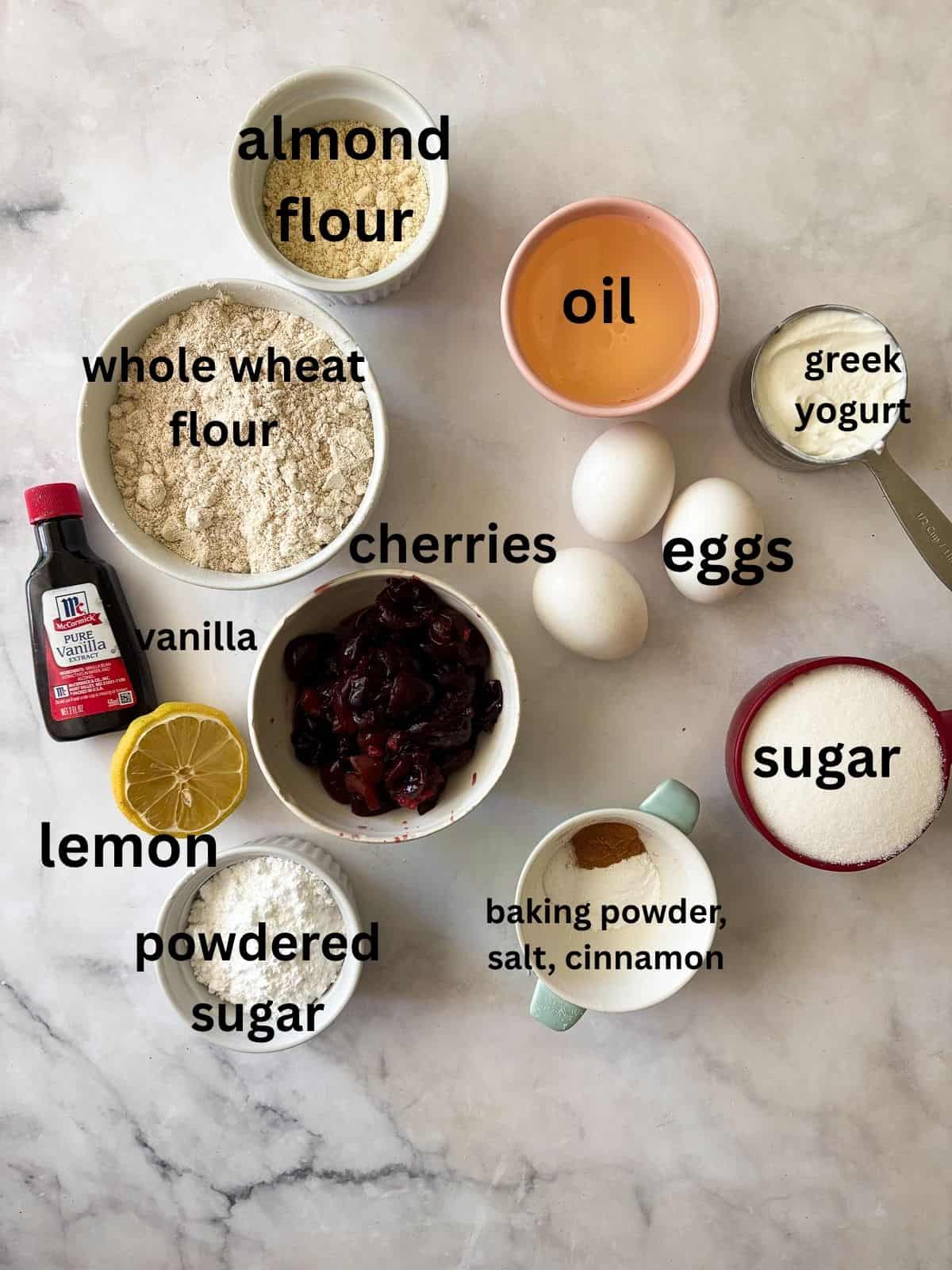 This pretty cherry bread is made in just one bowl and is finished with a lemon glaze. Whole grain flour, Greek yogurt - all the good stuff! Ingredients for cherry bread with lemon glaze are text-labeled.