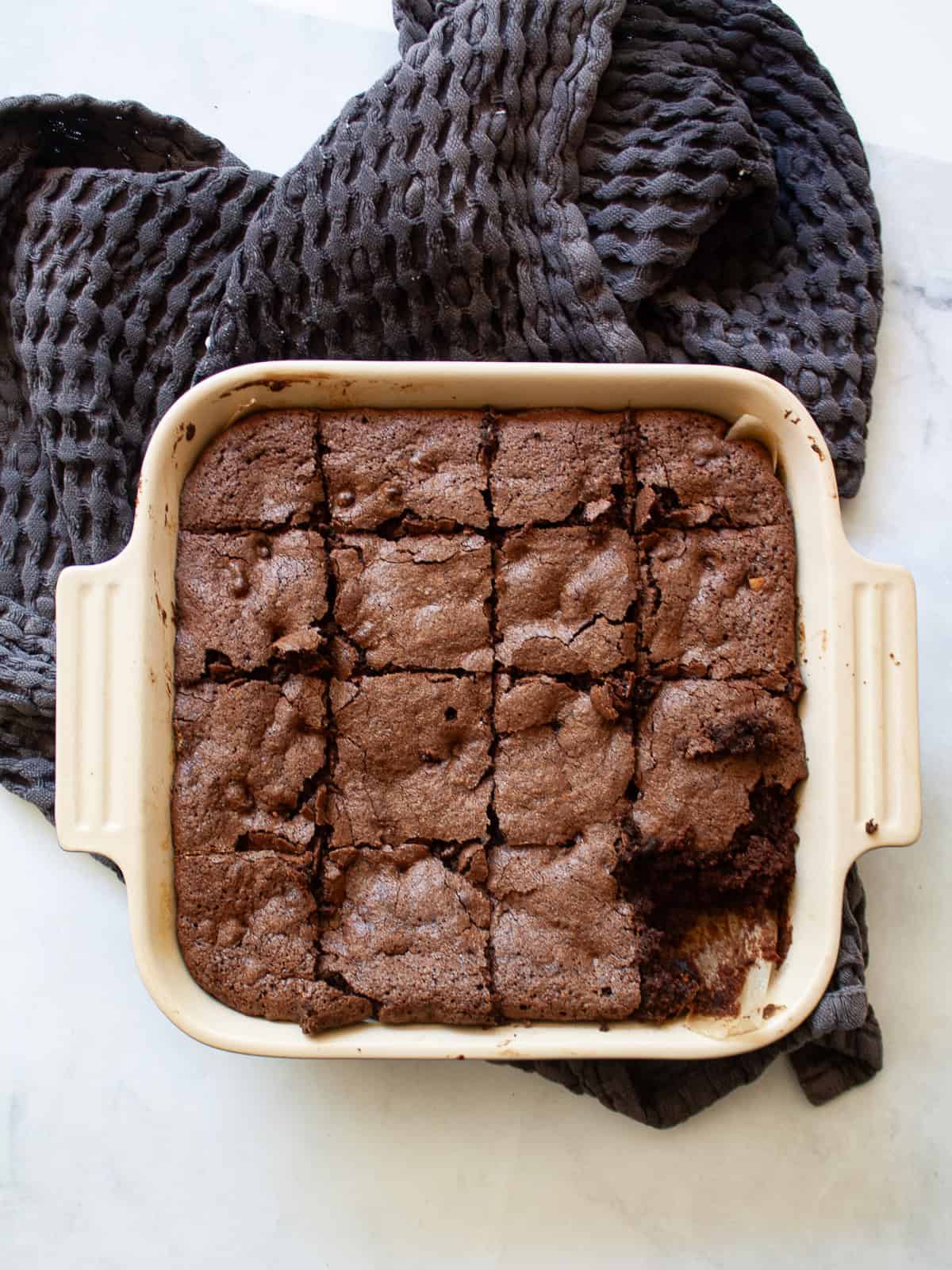Deeply rich and chocolatey almond flour brownies are both grain-free and gluten-free. So much better than a boxed mix! A pan of almond flour brownies with a square taken out.