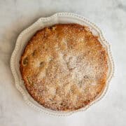 An apple rhubarb cake on a white plate.
