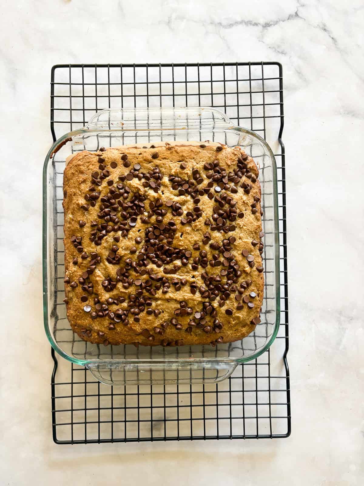 This banana snack cake is fluffy, moist, and balanced by warming spices. Naturally gluten-free, or make it with whole wheat flour. A banana snack cake cools in the pan.