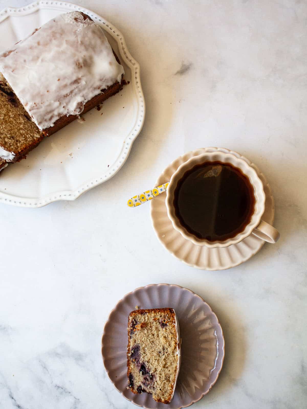 A loaf of cherry bread, a slice of bread, and a cup of tea.