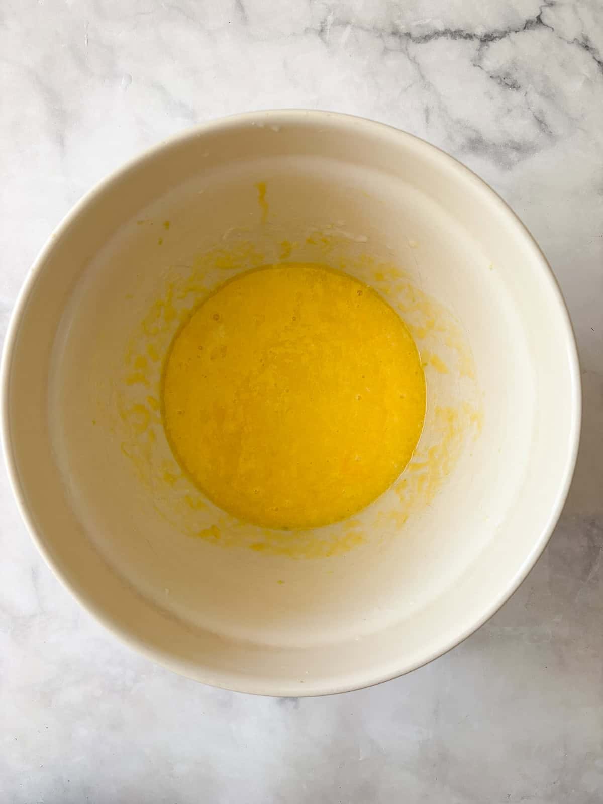 Eggs are whisked with yogurt and sugar for gluten free lemon blueberry bread.