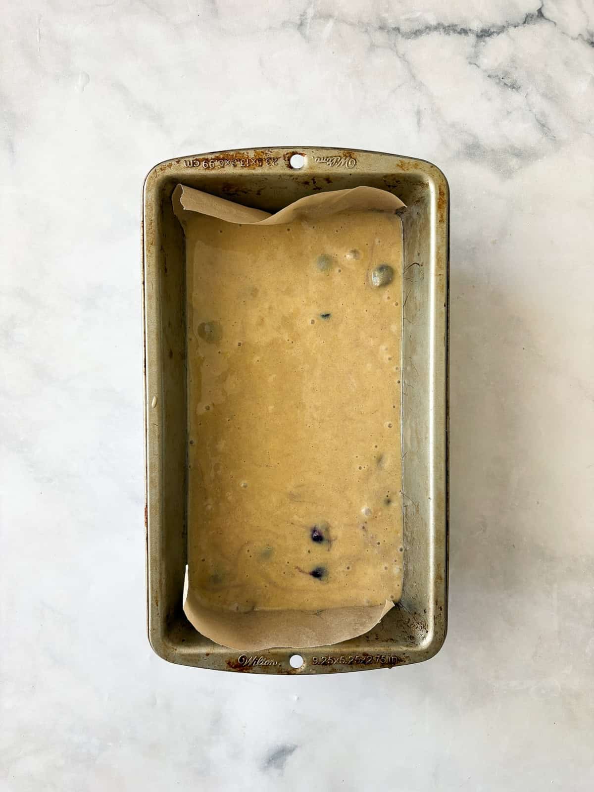 Gluten free lemon blueberry bread batter in a loaf pan.