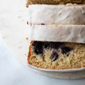 A sliced loaf of gluten free lemon blueberry bread.