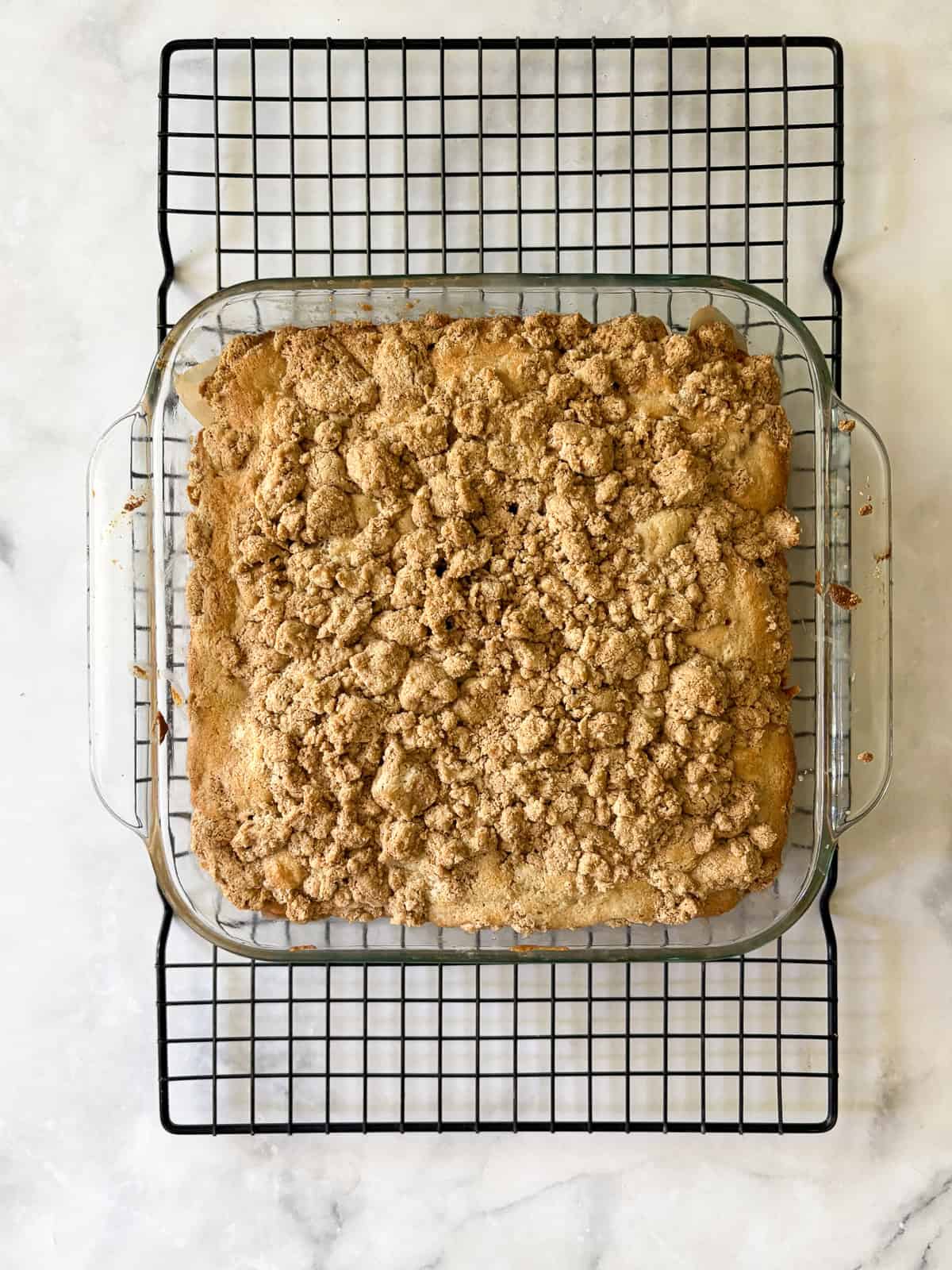 A soft and sweet gluten free rhubarb crumb cake with tart bits of rhubarb and a buttery, brown sugar streusel. Great for brunch! A gluten free rhubarb crumb cake cools in the pan.