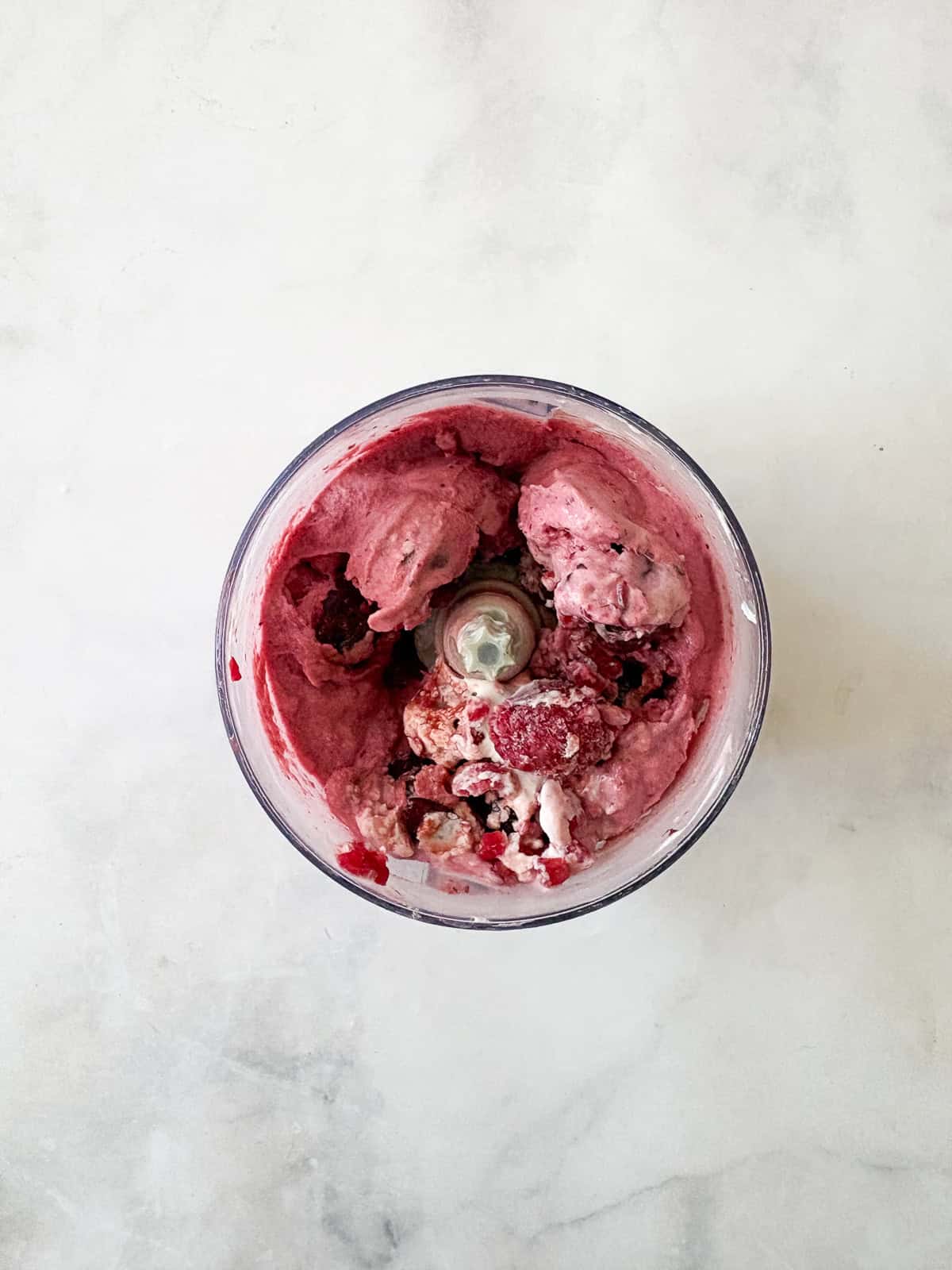 Just two ingredients - fruit and yogurt - plus a food processor are needed to make this refreshing and easy homemade Greek frozen yogurt. Midway through processing Greek frozen yogurt.
