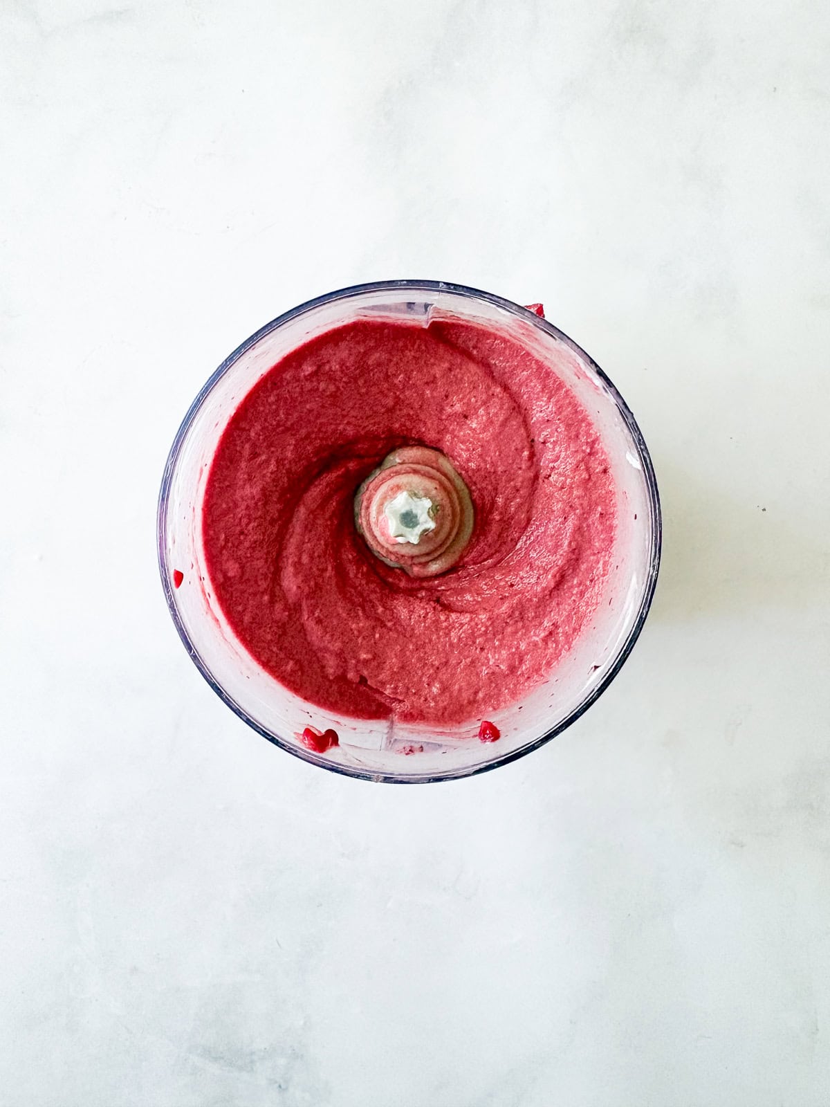 Just two ingredients - fruit and yogurt - plus a food processor are needed to make this refreshing and easy homemade Greek frozen yogurt. The frozen yogurt after being processed.