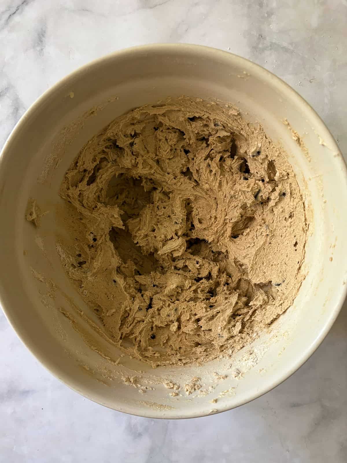 One of my favorite types of cookies, these maple chocolate chip cookies are sweetened with a combination of maple syrup and brown sugar. Maple syrup chocolate chip cookie dough in a bowl.