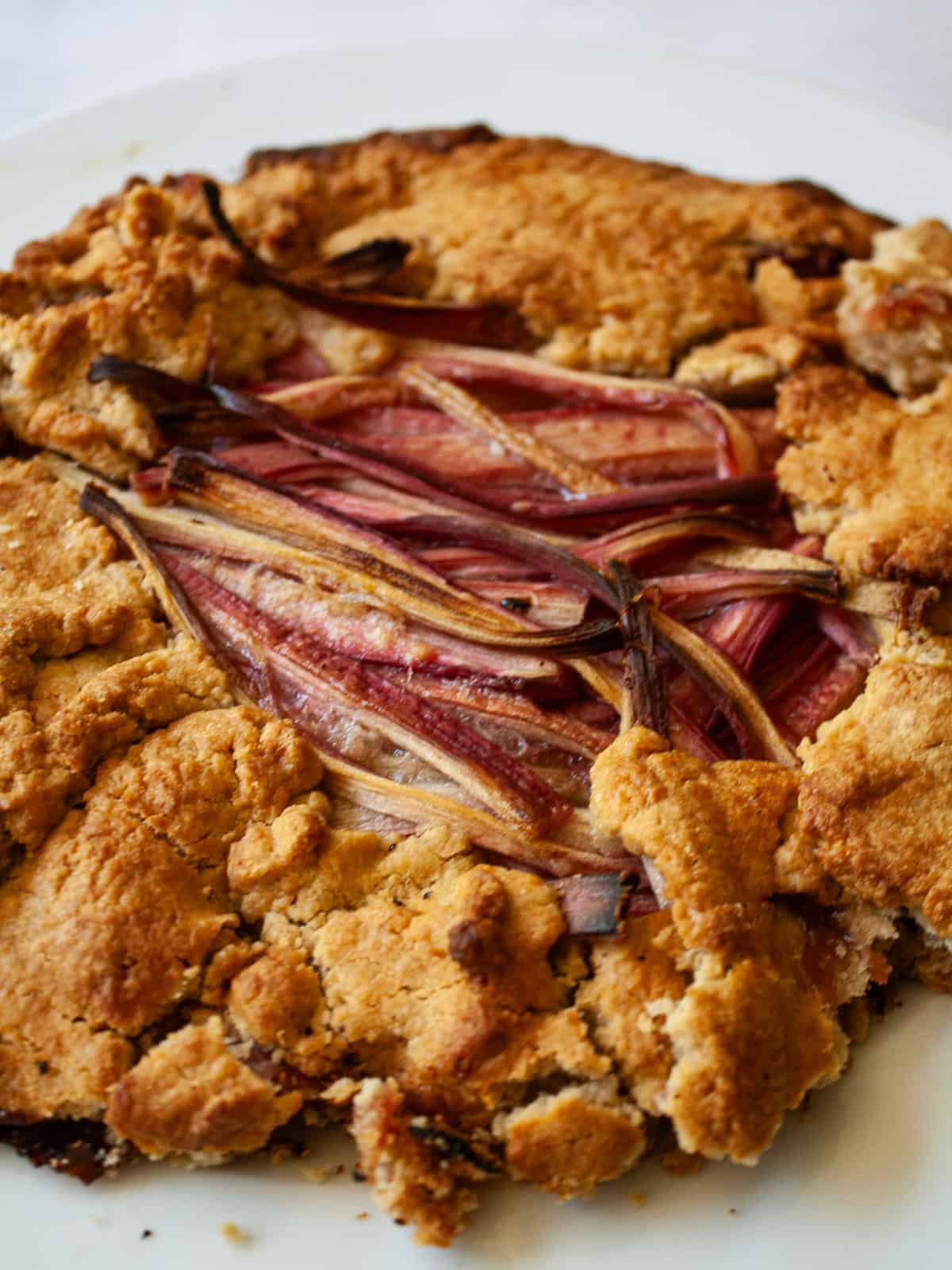 This rhubarb galette features a flaky, whole-grain crust folded around a jammy filling. Rhubarb's flavor truly shines in this rustic bake. A rustic rhubarb galette.