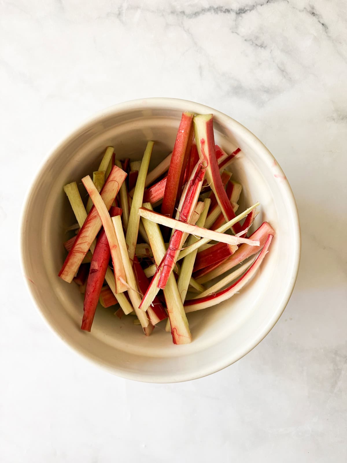 This rhubarb galette features a flaky, whole-grain crust folded around a jammy filling. Rhubarb's flavor truly shines in this rustic bake. A detail showing how to cut the rhubarb.