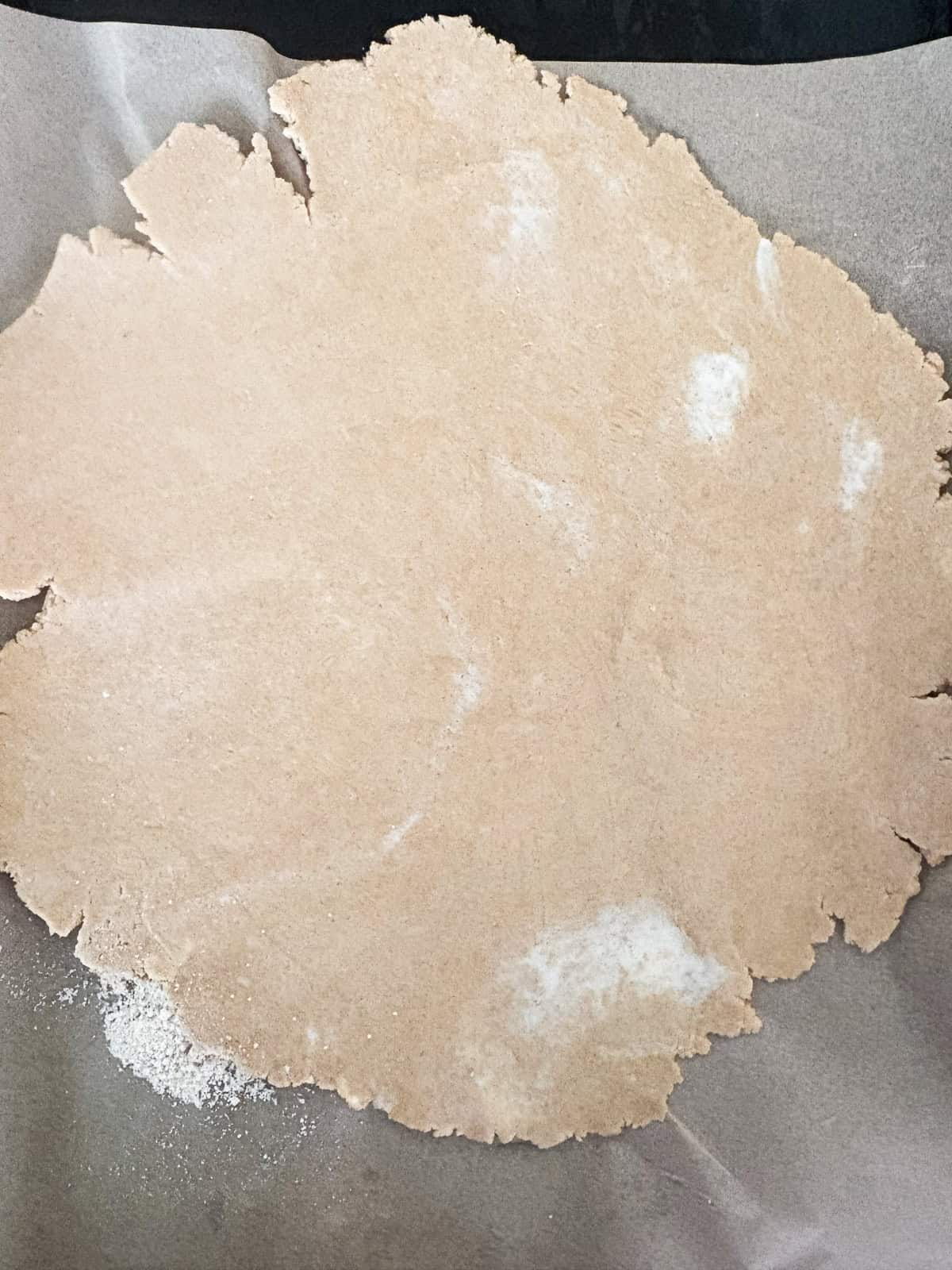This rhubarb galette features a flaky, whole-grain crust folded around a jammy filling. Rhubarb's flavor truly shines in this rustic bake. Galette dough is rolled out into a circle.