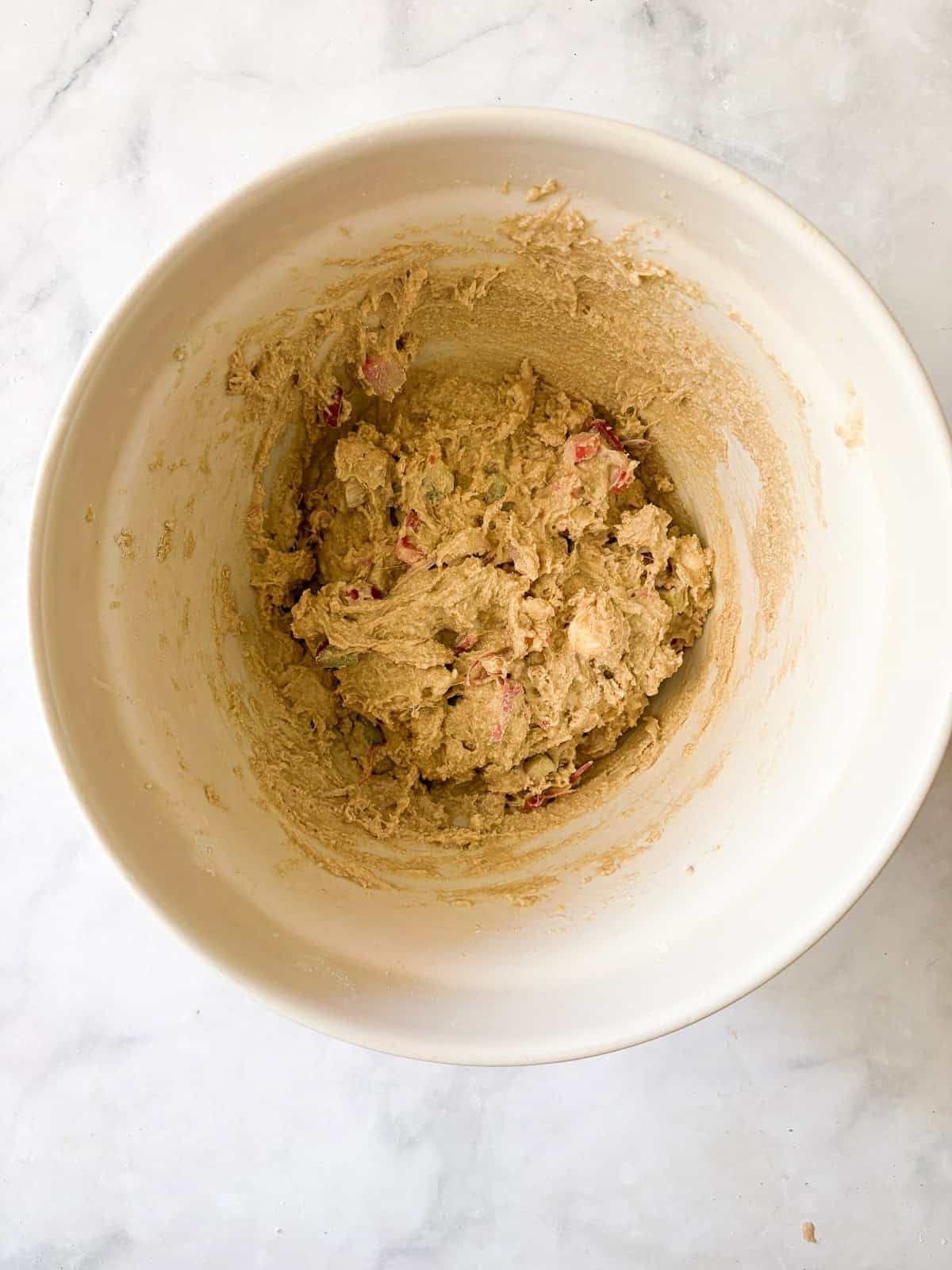 Tender and flaky whole grain strawberry rhubarb scones are a perfect summer morning treat. Make these with whole wheat or gf oat flour. Dough for strawberry rhubarb scones in a bowl.