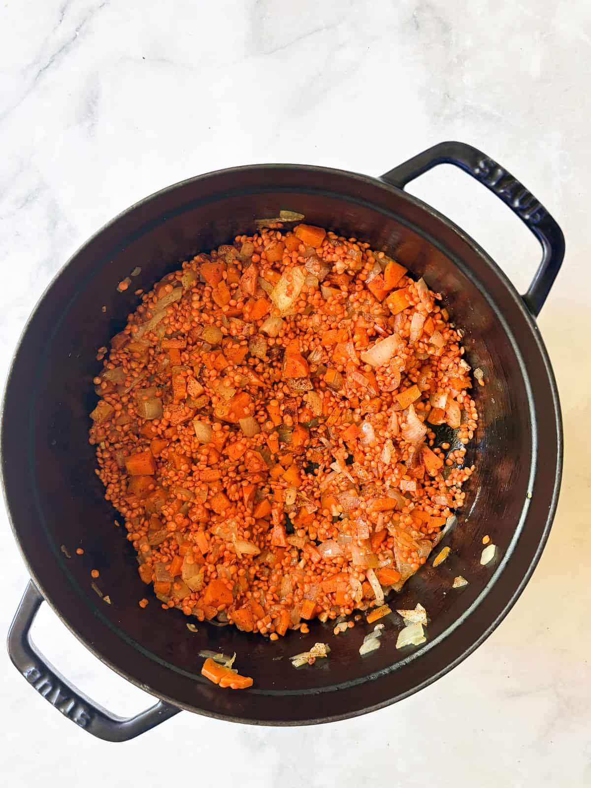 A hearty vegetarian red lentil stew that's packed with vegetables to make a satisfying dinner. Easy to adapt and make-ahead friendly. Red lentils are tossed with aromatics and spices.