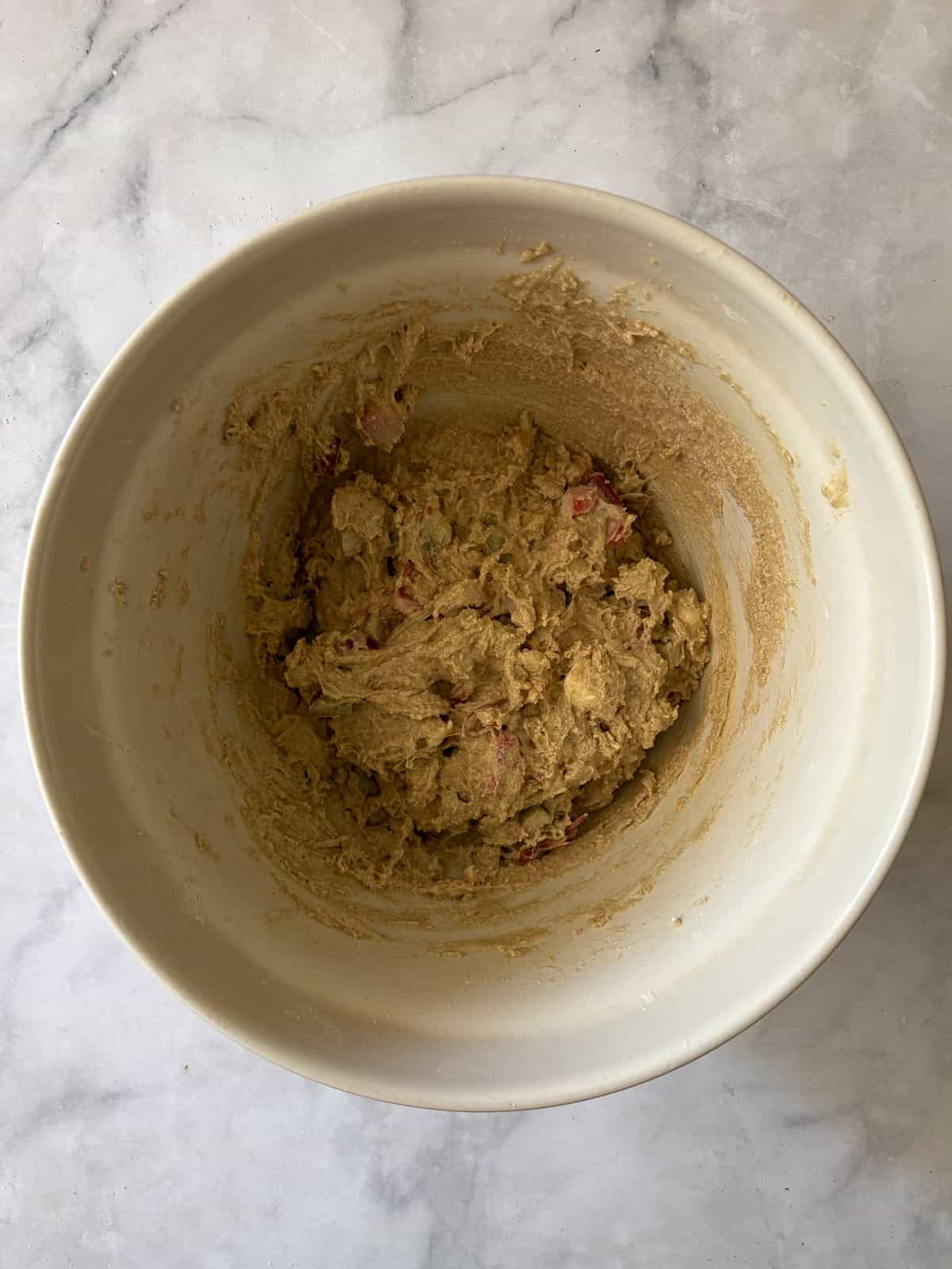 Tender, flaky rhubarb scones made with whole wheat flour and lots of tart spring rhubarb and a hint of orange zest. Dough for whole wheat rhubarb scones in a bowl.