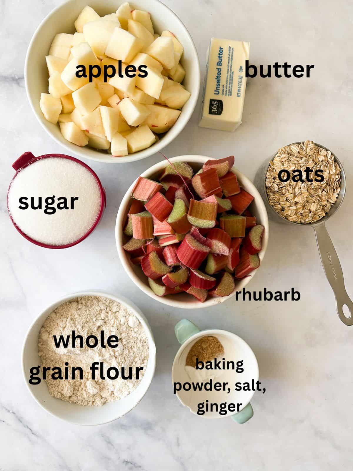 A jammy apple rhubarb crisp pairs seasonal rhubarb with sweet apples. Make the buttery oat topping gluten-free or use whole wheat flour. Ingredients for rhubarb apple crisp are text-labeled.