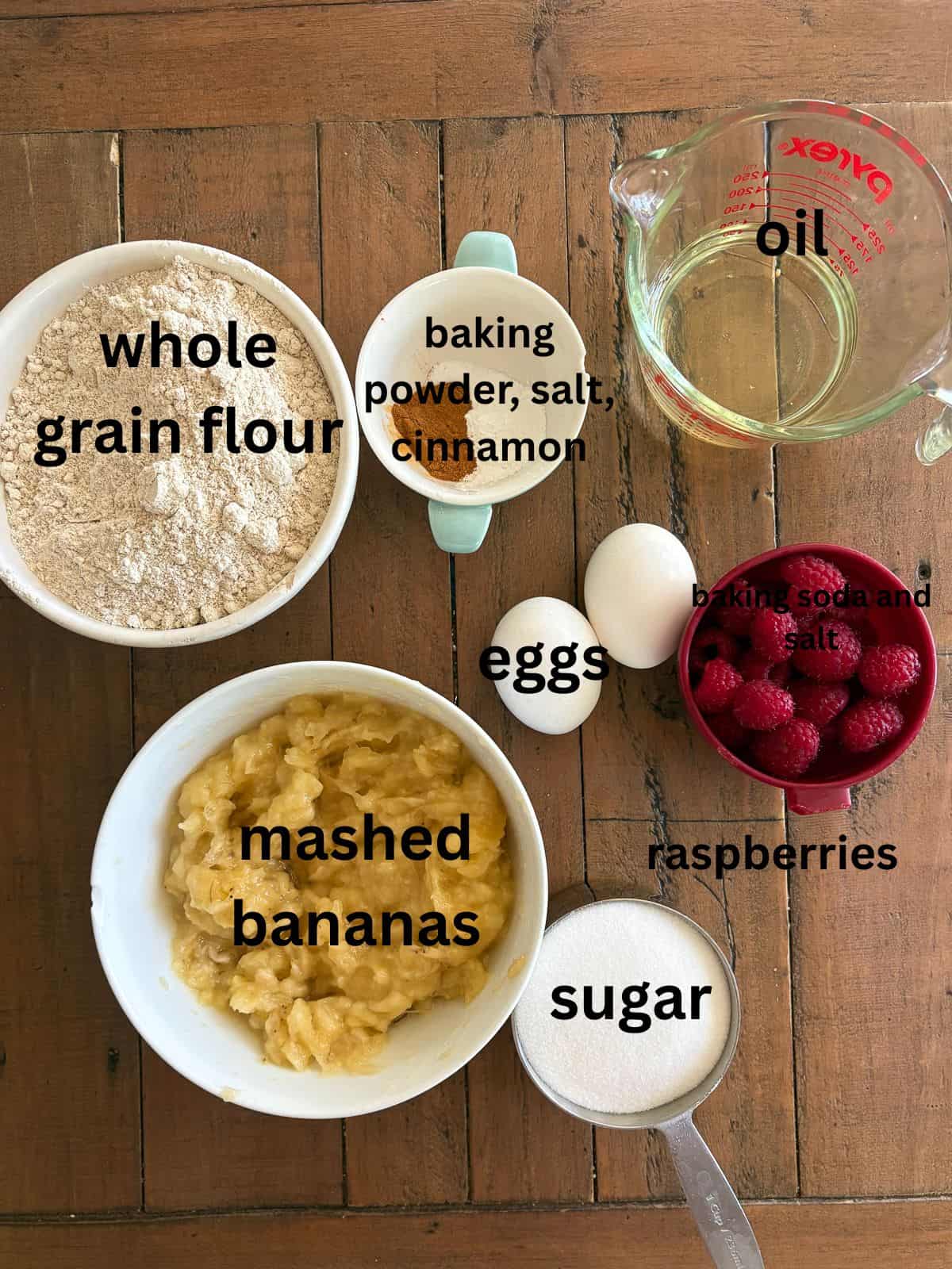 An uptick on a classic, this whole-grain raspberry banana bread features a soft, tender bread studded with juicy pockets of raspberries. Ingredients for banana raspberry bread are text-labeled.