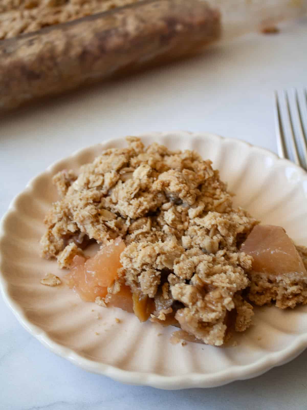 A piece of rhubarb apple crisp on a plate.