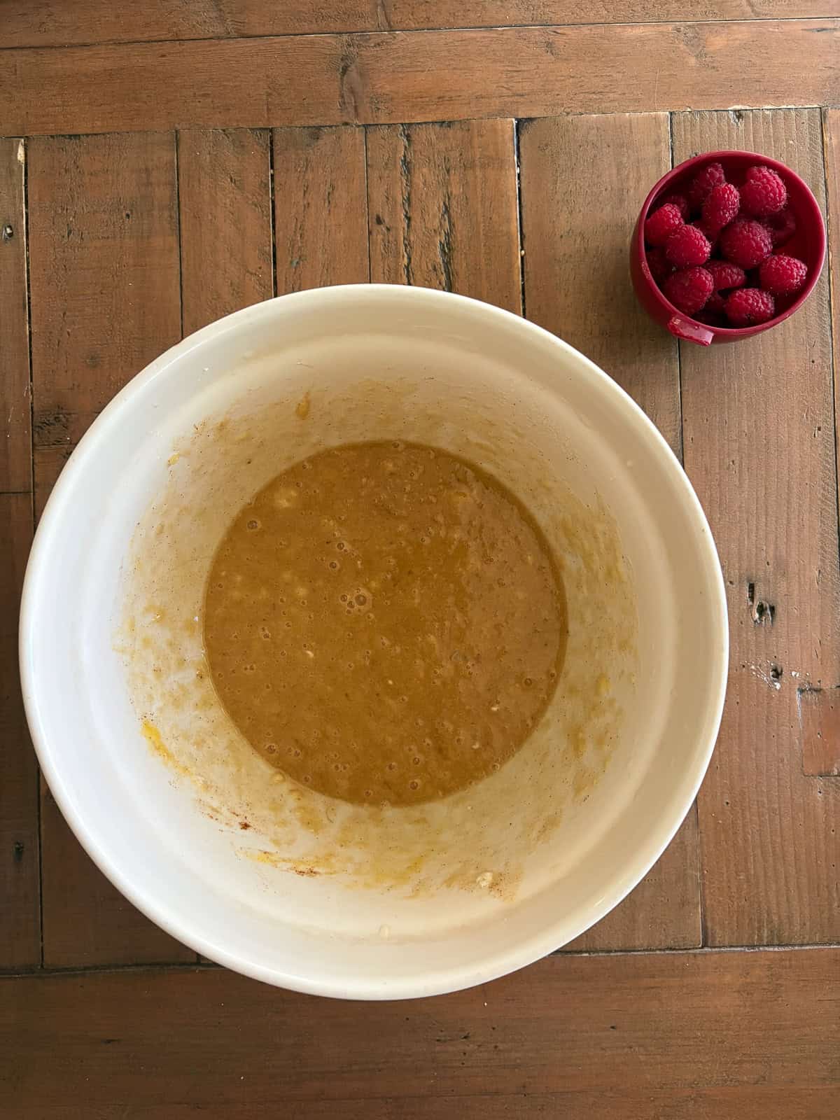 An uptick on a classic, this whole-grain raspberry banana bread features a soft, tender bread studded with juicy pockets of raspberries. The batter for banana raspberry bread in a big bowl.