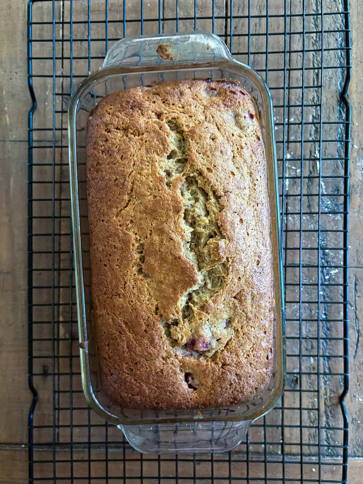 An uptick on a classic, this whole-grain raspberry banana bread features a soft, tender bread studded with juicy pockets of raspberries. A loaf of raspberry banana bread cools.