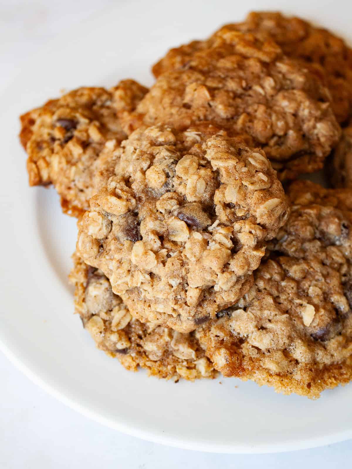 Soft and chewy-crisp chocolate chip oatmeal cookies are packed with the good stuff - butter, rolled oats, whole grain flour, and chocolate! A plate of chocolate chip oatmeal cookies.