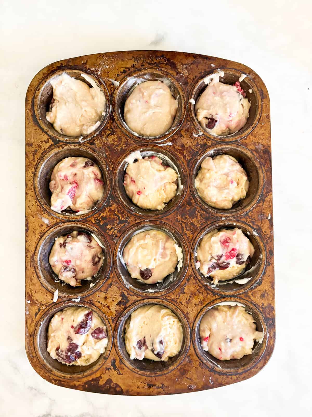 Soft and tender chocolate chip raspberry muffins are made with whole grain flour (easily gluten-free), fruit, and semisweet chocolate!