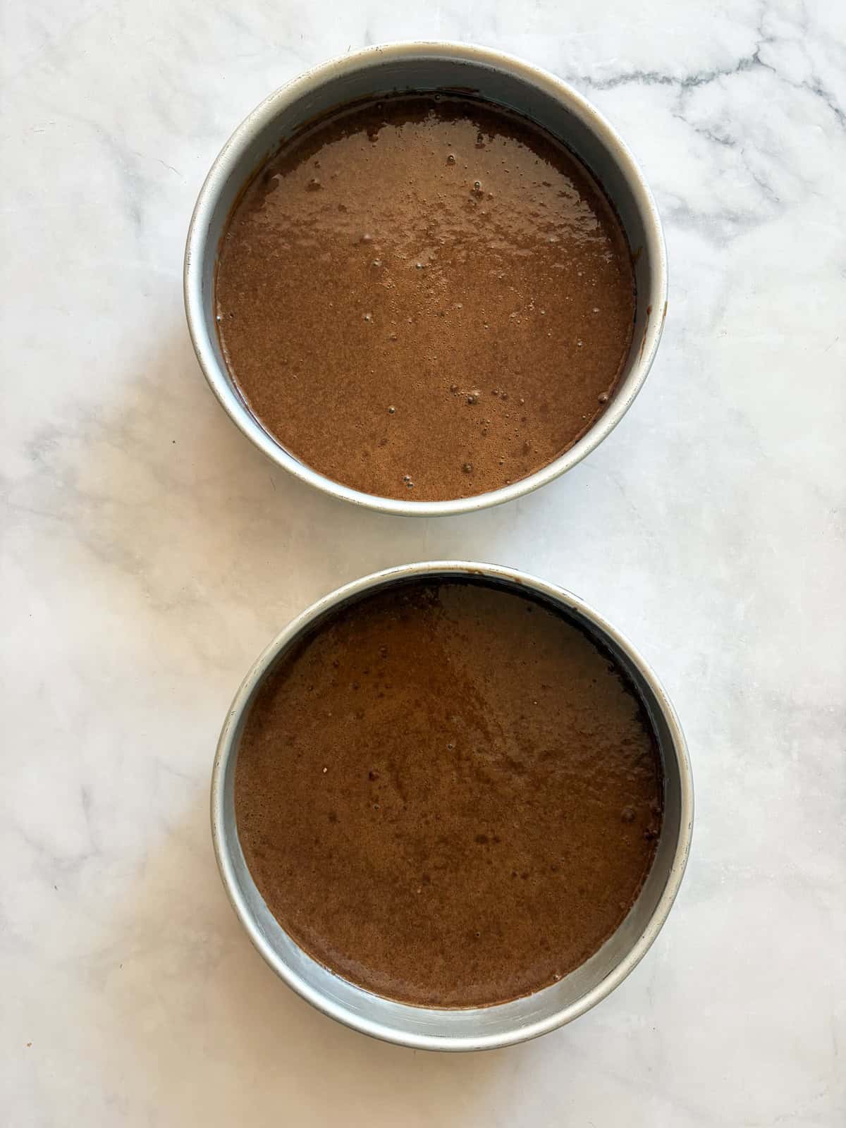 This tender, naturally higher-protein chocolate cake delivers 8 grams of protein per slice from whole foods ingredients. NO protein powder! Batter for protein chocolate cake in a cake rounds.
