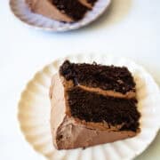A two-layer higher protein chocolate cake slice on a plate.