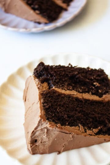A two-layer higher protein chocolate cake slice on a plate.