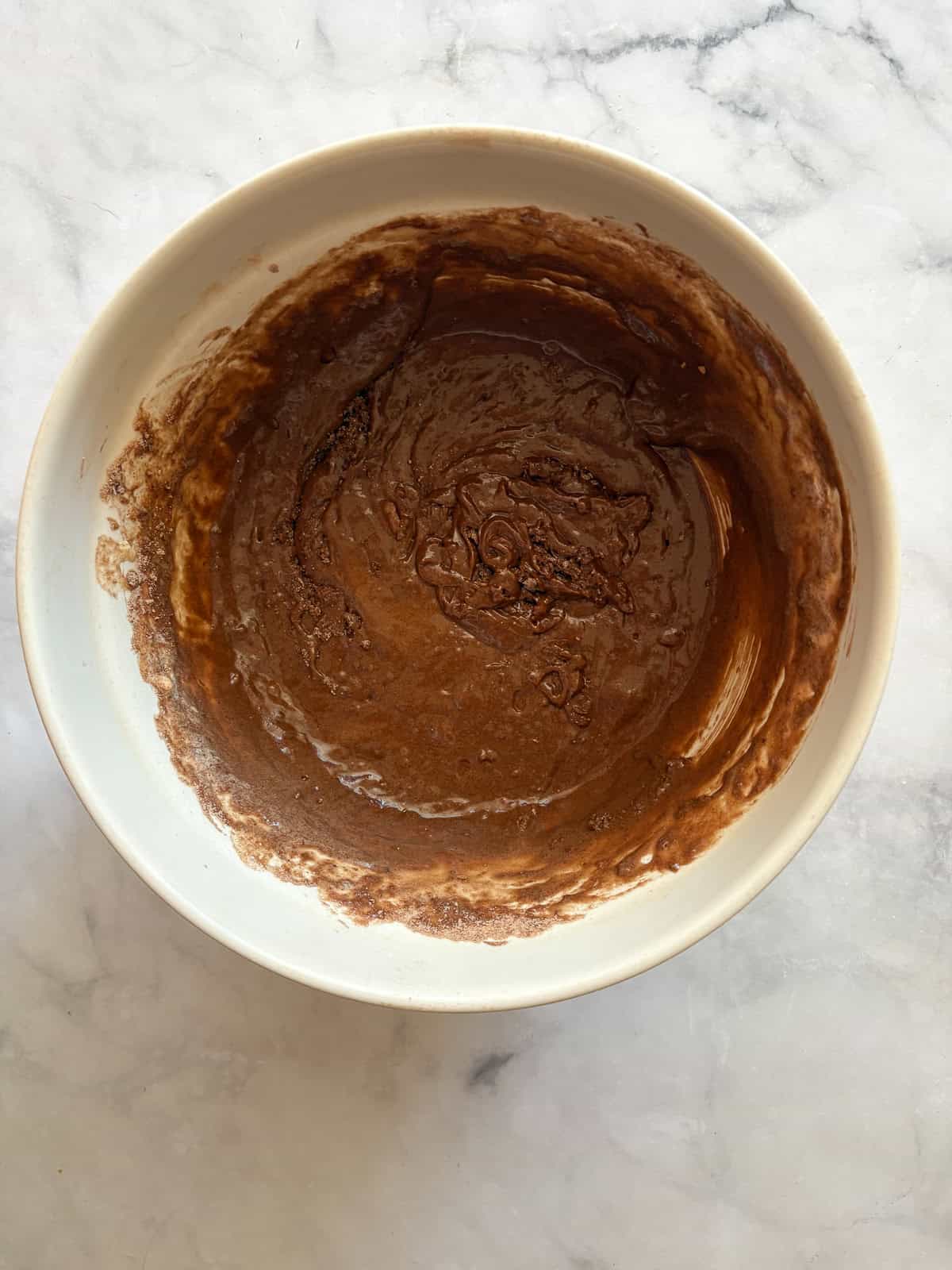 This tender, naturally higher-protein chocolate cake delivers 8 grams of protein per slice from whole foods ingredients. NO protein powder! Protein chocolate cake batter in a bowl.