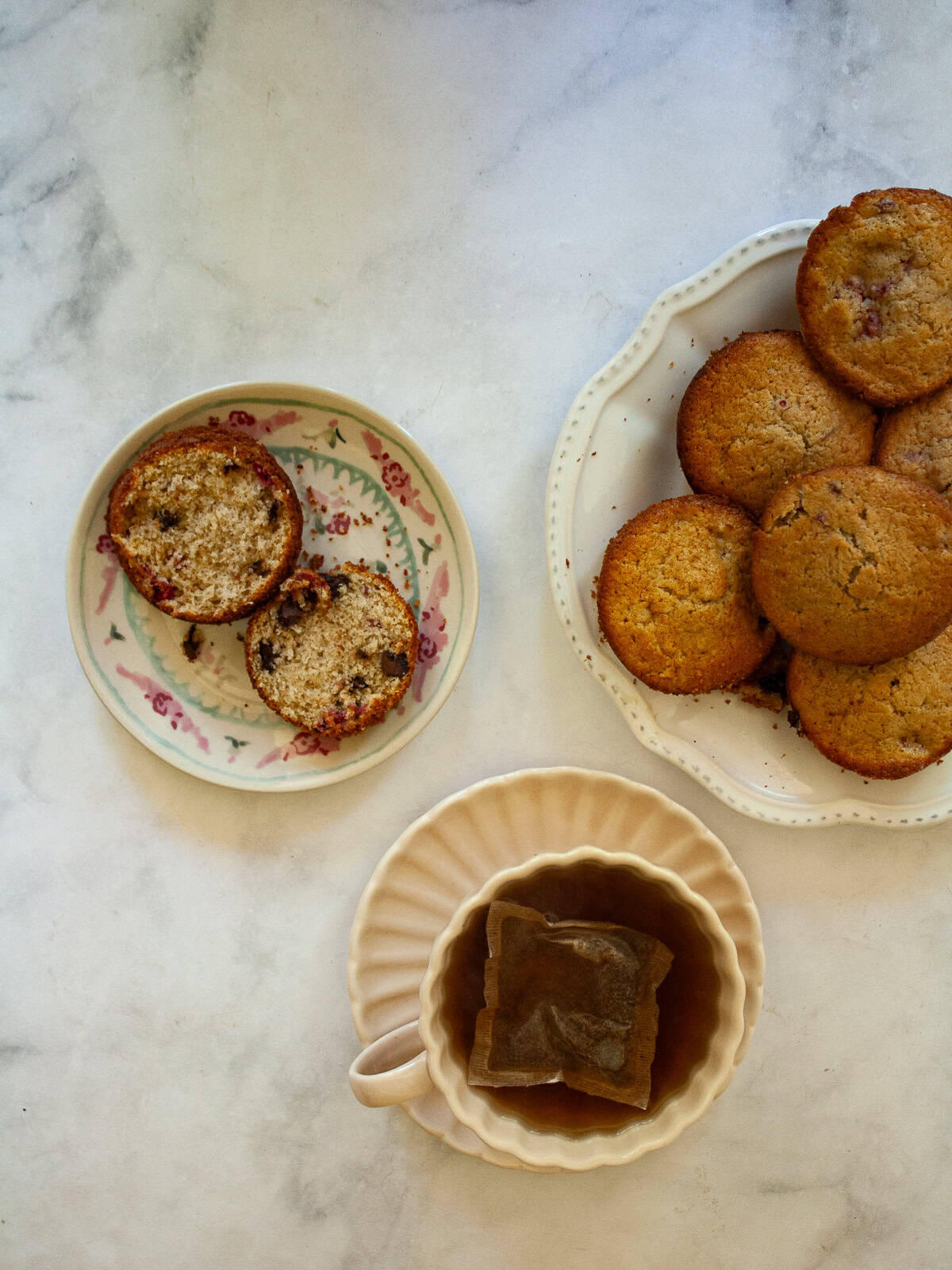 Soft and tender chocolate chip raspberry muffins are made with whole grain flour (easily gluten-free), fruit, and semisweet chocolate! Chocolate chip raspberry muffins and a cup of coffee.