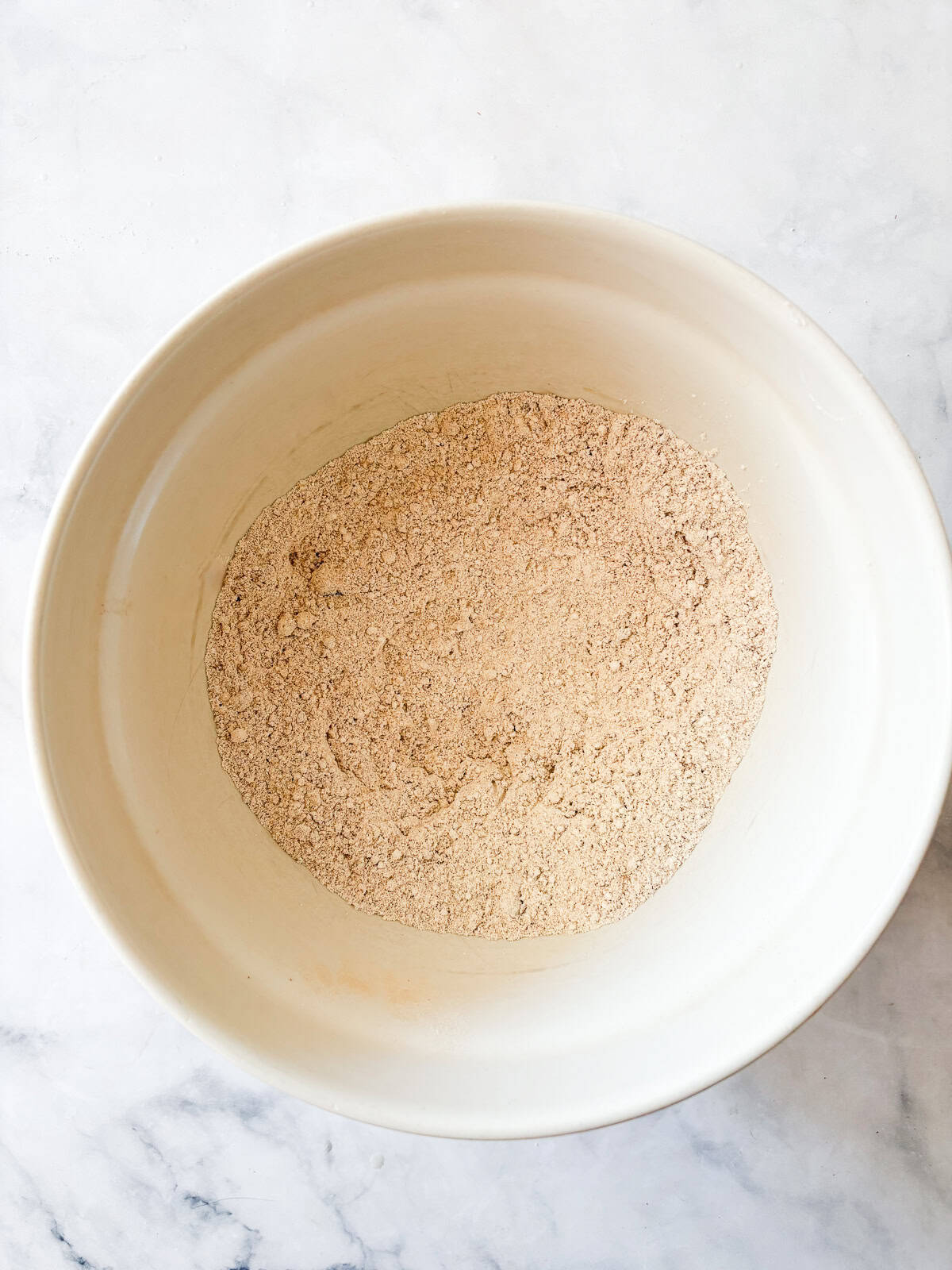 These strawberry pancakes feature fresh, juicy strawberries, whole grain flour, and a light and fluffy crumb. Gluten-free if needed. Dry ingredients are whisked in a bowl for strawberry pancakes.