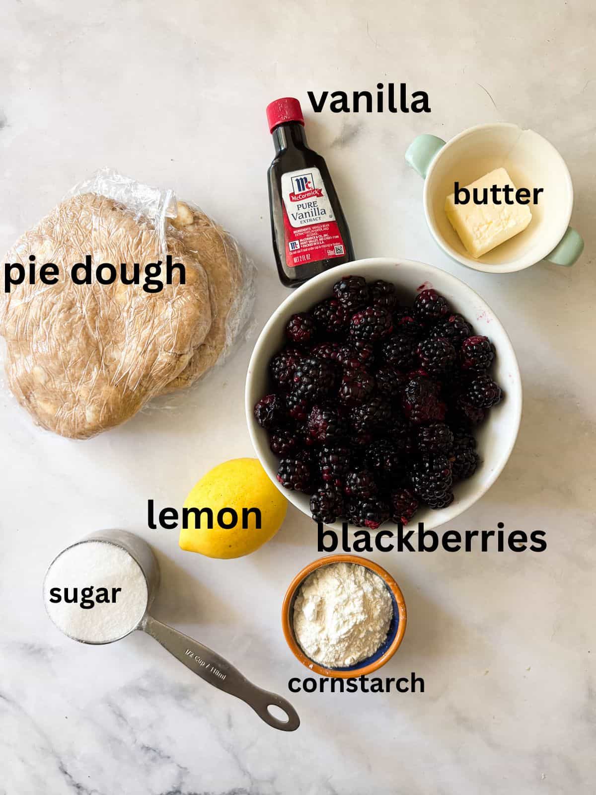 A simple method and ingredients makes this blackberry pie an easy, delicious summer bake. Make gluten-free or not, as needed! Ingredients for homemade blackberry pie are text-labeled.