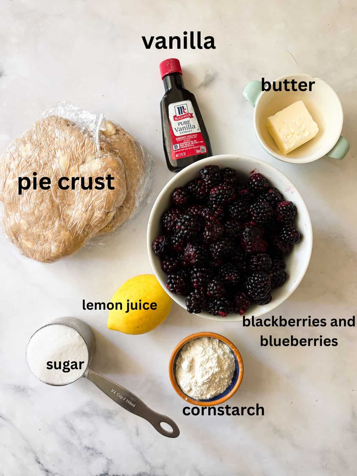 A classic method is used to make this blueberry blackberry pie, which features fresh summer berries folded into a tender crust. Ingredients for a blueberry blackberry pie are text-labeled.