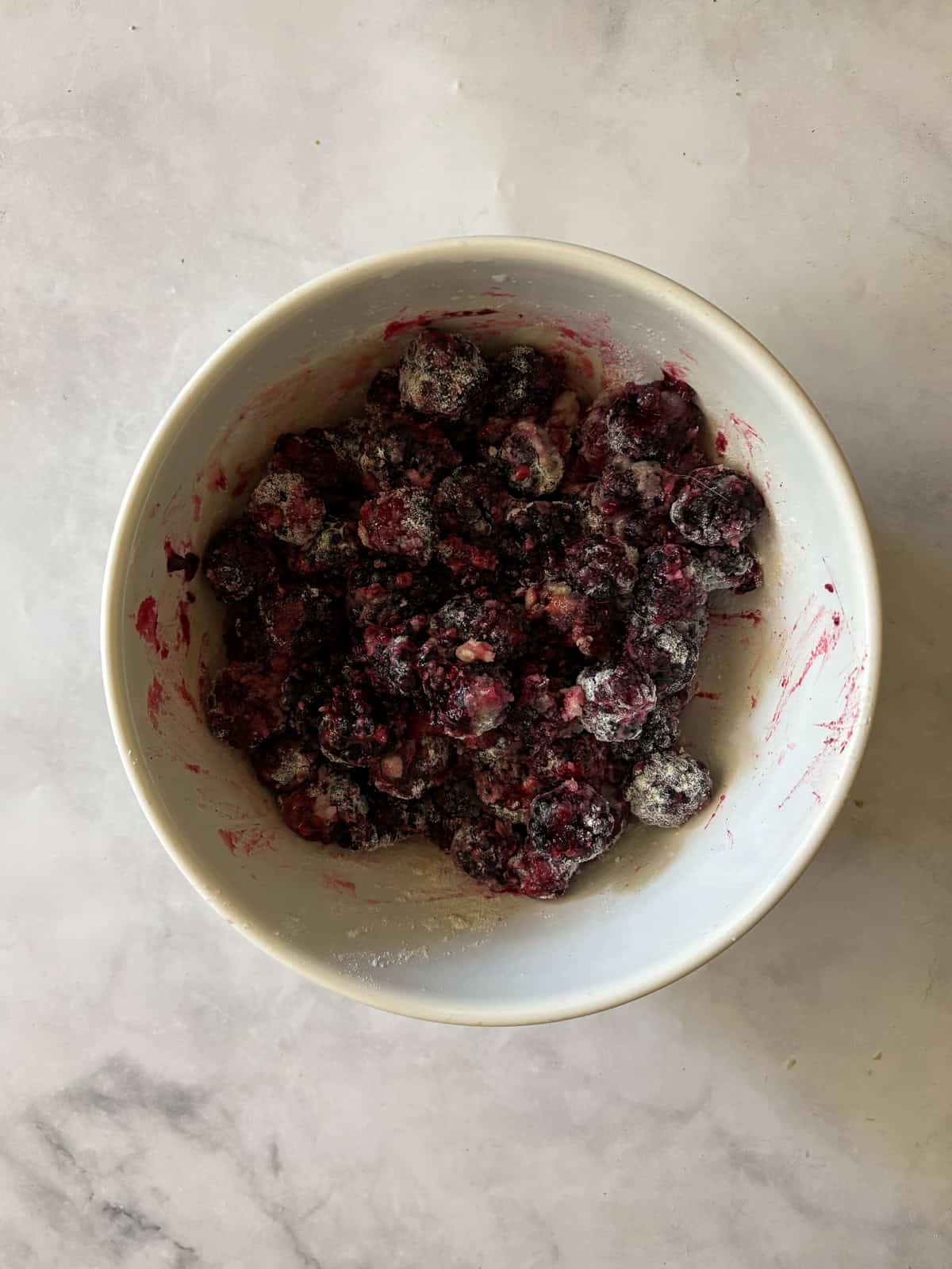 A simple method and ingredients makes this blackberry pie an easy, delicious summer bake. Make gluten-free or not, as needed! Blackberry pie filling in a bowl.