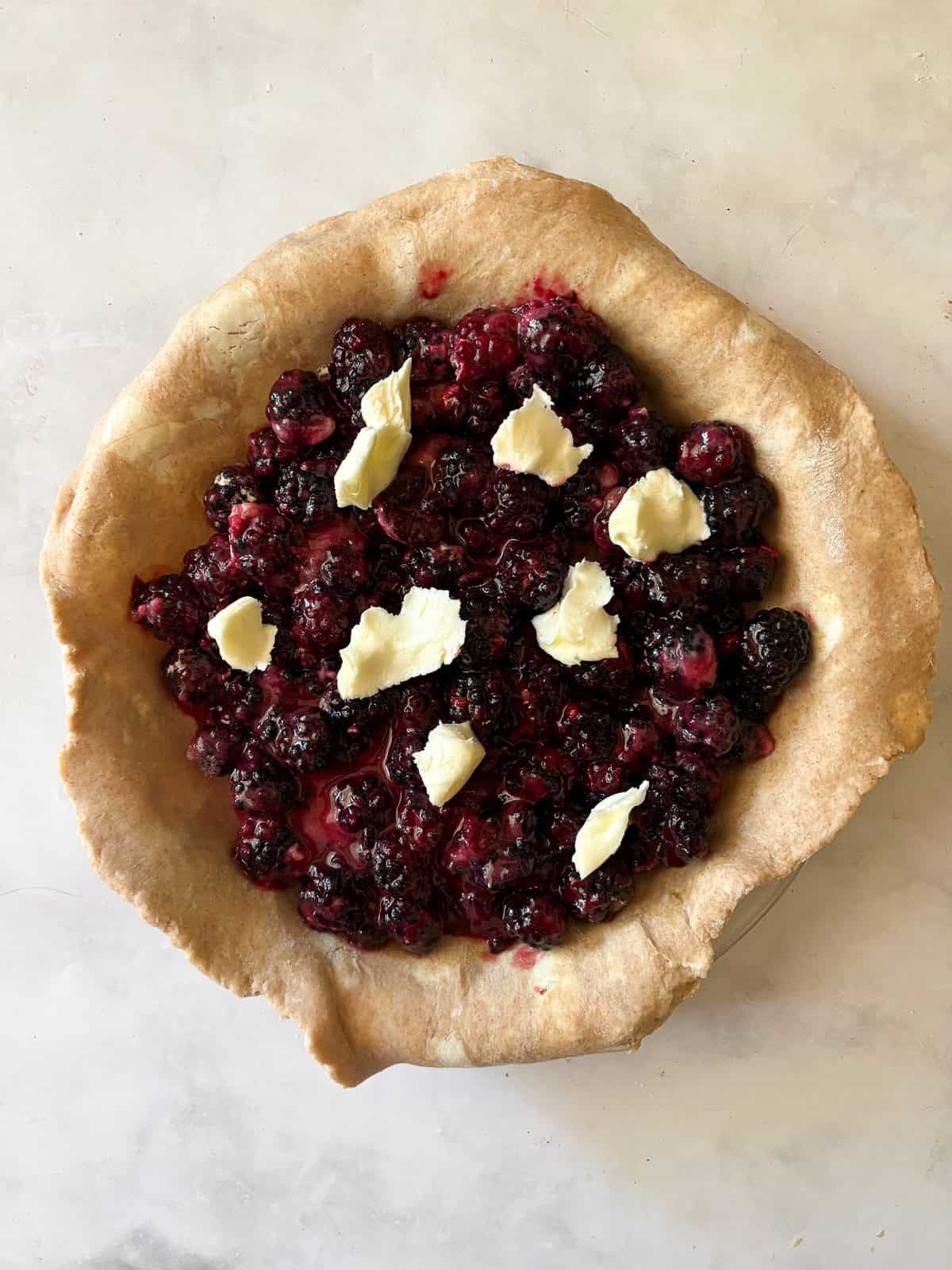 A classic method is used to make this blueberry blackberry pie, which features fresh summer berries folded into a tender crust. Assembling the blueberry blackberry pie.