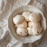 A bowl of chocolate chip meringue cookies on a napkin.