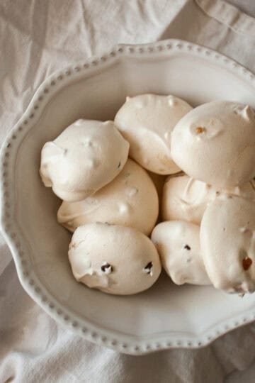 A bowl of chocolate chip meringue cookies on a napkin.