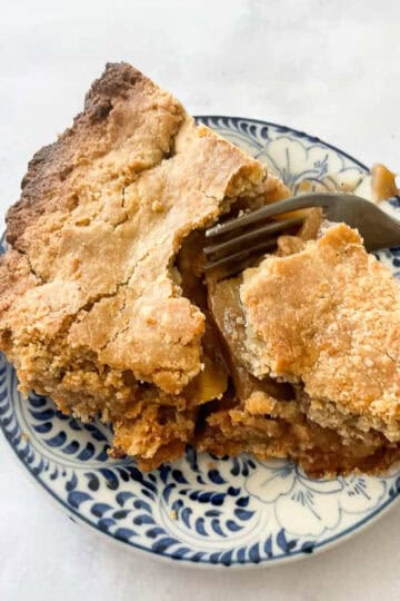 A slice of Gravenstein apple pie on a plate.