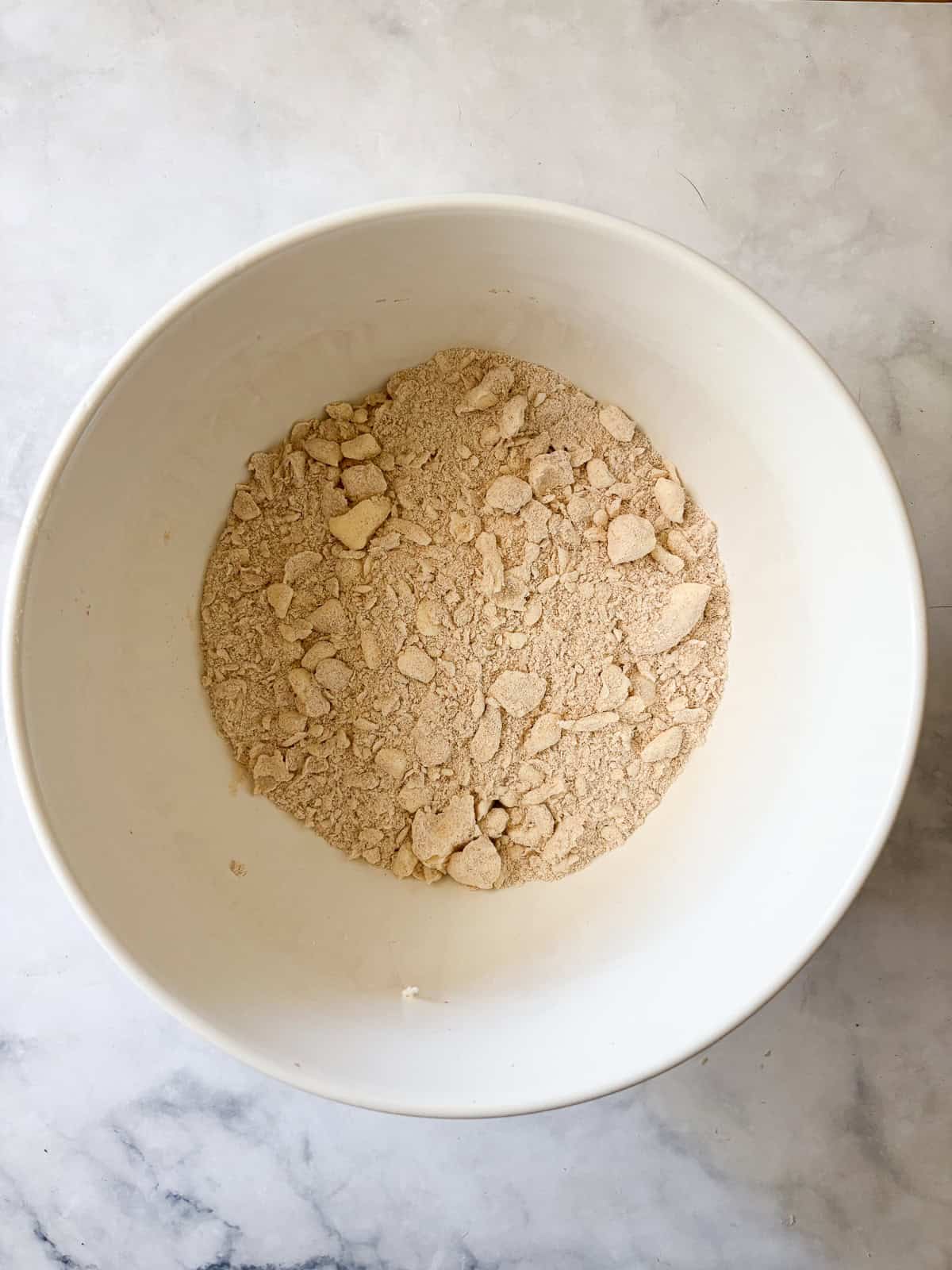 Whole grain flour adds nutrition and flavor to this flaky whole wheat pie crust. Use it in your favorite pies, galettes, and more. Butter is worked into whole wheat flour for whole wheat pie crust.