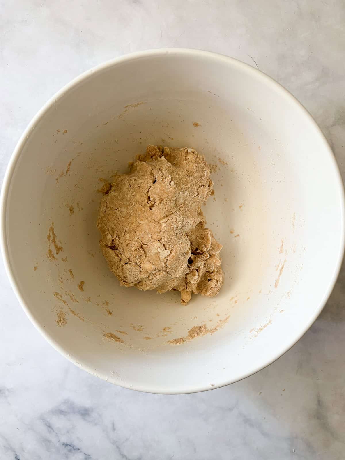 Whole grain flour adds nutrition and flavor to this flaky whole wheat pie crust. Use it in your favorite pies, galettes, and more. The whole wheat pie crust dough comes together in a bowl.