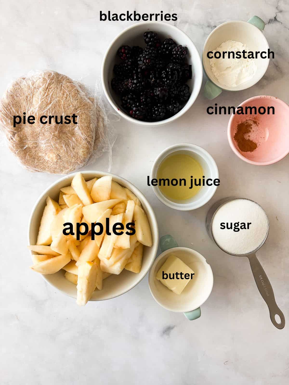 Juicy apples combine with sun-warmed blackberries in this apple blackberry pie. Choose a homemade, gluten-free, or store-bought pie crust. Ingredients for apple blackberry pie are text labeled.